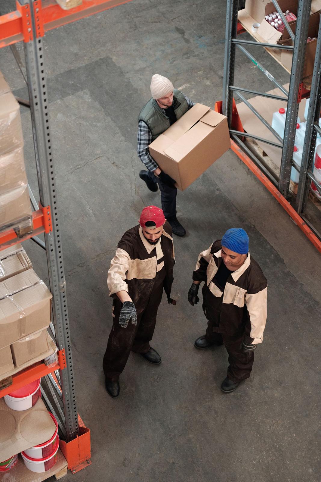 Team of workers managing inventory in a warehouse, emphasizing logistics and teamwork