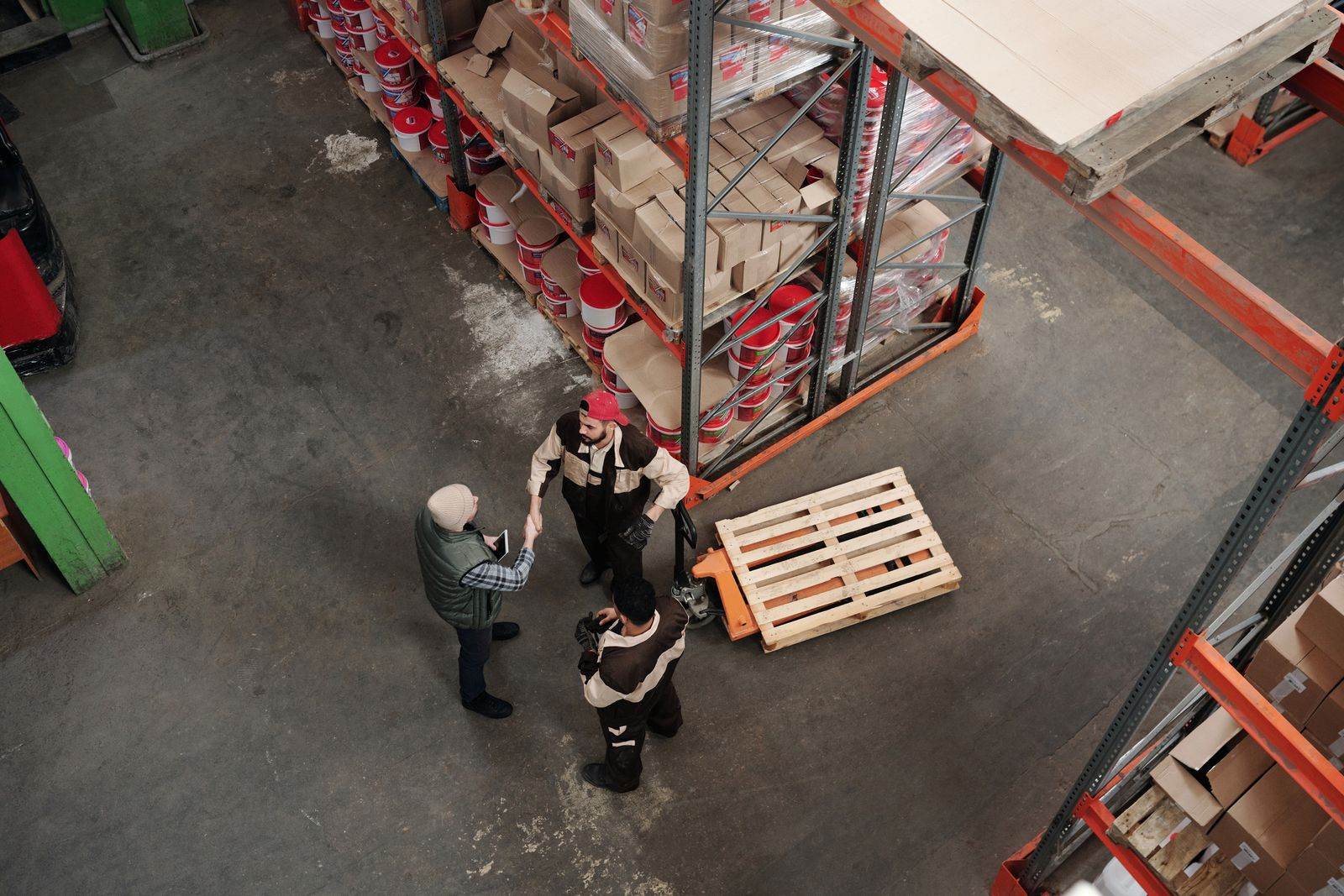 High angle view of workers discussing logistics in a warehouse setting