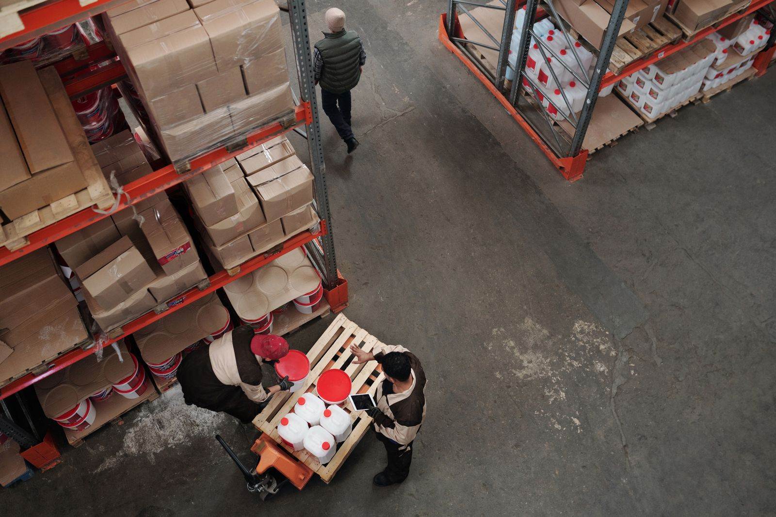 High angle view of warehouse workers handling inventory and logistics operations